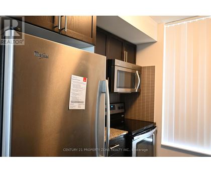 A stainless steel refrigerator with a note attached to it.