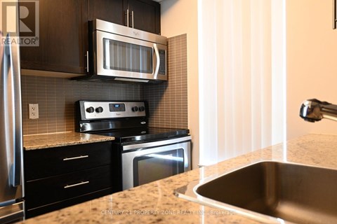 A kitchen with a stove top oven and microwave above it.