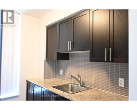 A kitchen with a sink and cabinets.
