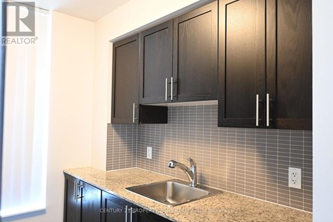 A kitchen with a sink and cabinets.