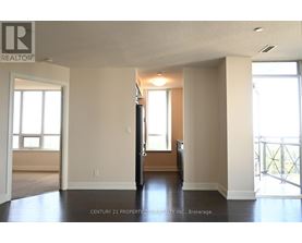 A spacious room with a door in the middle and windows on the wall.