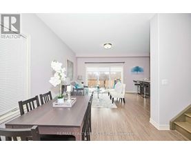 A dining room with a wooden table and chairs.