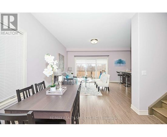 A dining room with a wooden table and chairs.