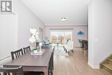 A dining room with a wooden table and chairs.