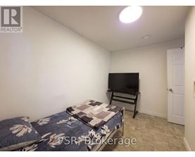 A bedroom with a bed and a television in it.