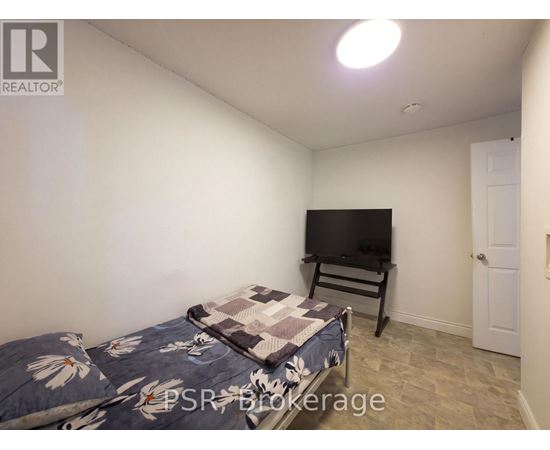 A bedroom with a bed and a television in it.