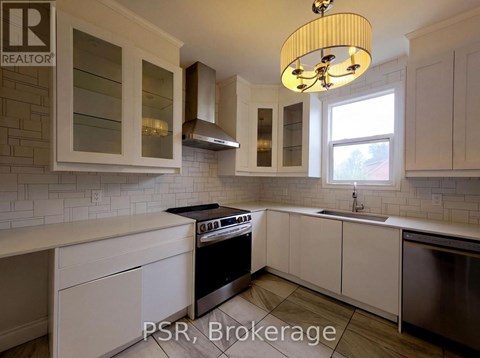 A kitchen with white cabinets and a black stove top oven.