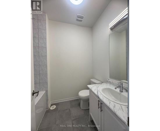 A bathroom with a toilet, sink, and shower.