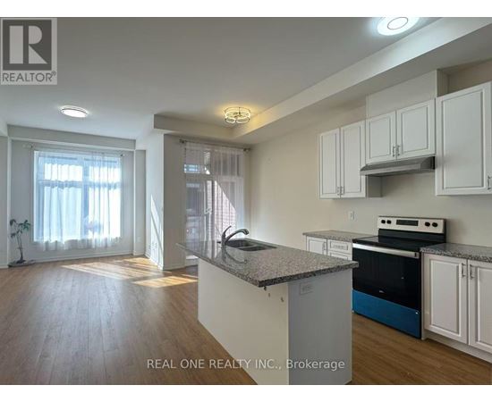 A kitchen with white cabinets and a granite countertop.