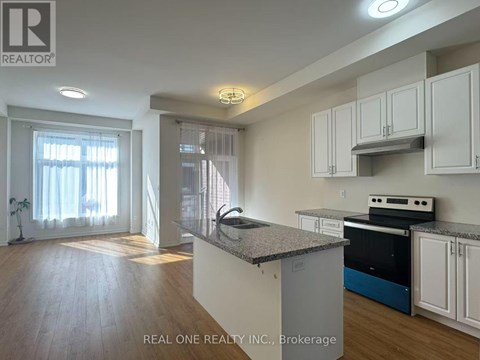 A kitchen with white cabinets and a granite countertop.