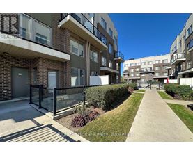 A sunny day at a residential area with apartment buildings and a clear blue sky.