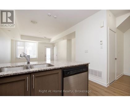 A kitchen with a sink and a dishwasher.