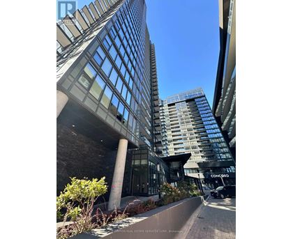 A tall building with a glass facade is seen in the image.