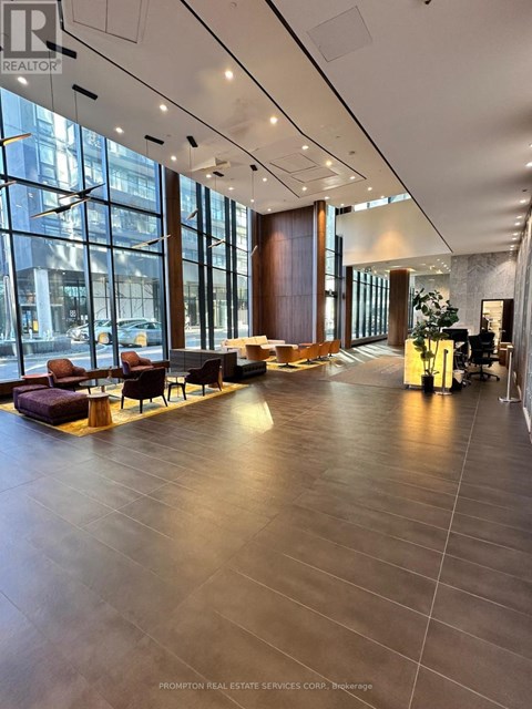 A spacious waiting area with a long wooden table and chairs.
