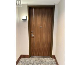 A wooden door with a glass panel and a handle.
