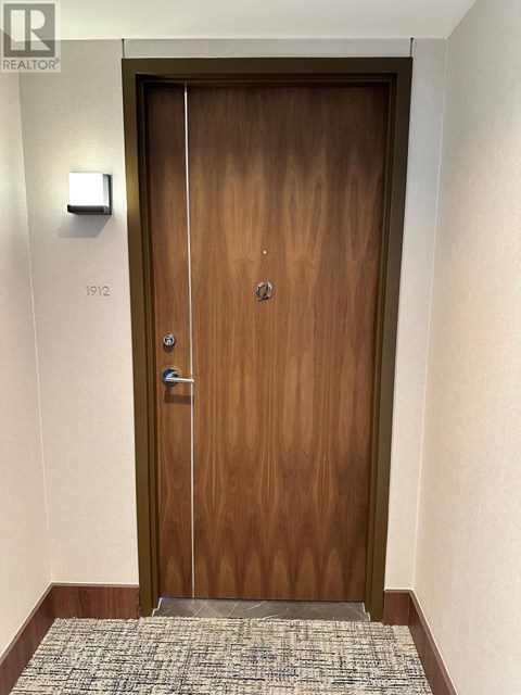A wooden door with a glass panel and a handle.
