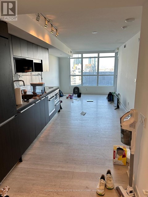 A kitchen with a black counter top and a white wall.