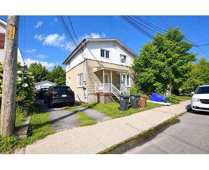A house with a car parked in front of it.