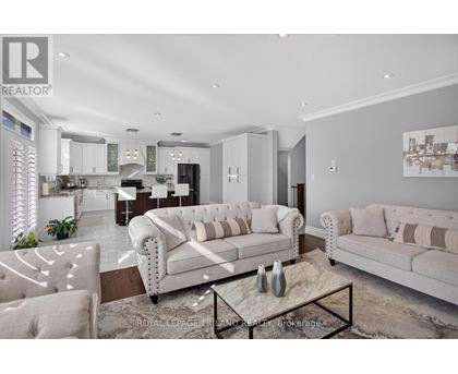 A modern living room with a white sofa and a coffee table.