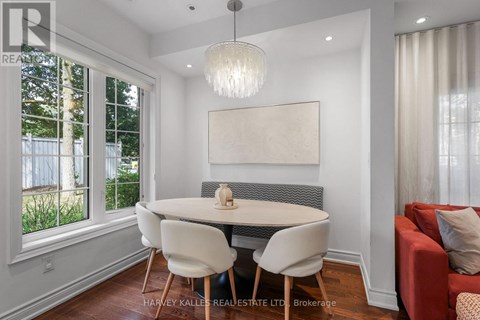 A dining room with a white table and chairs.