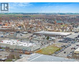 A bird's eye view of a town with a large building in the foreground.