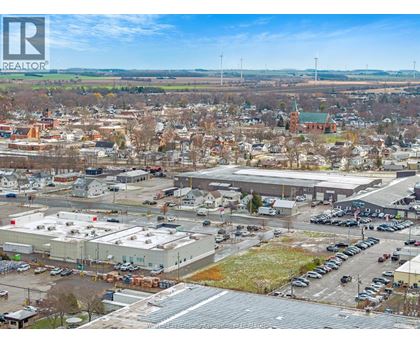 A bird's eye view of a town with a large building in the foreground.