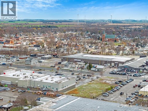 A bird's eye view of a town with a large building in the foreground.