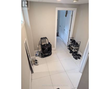 A room with a vacuum cleaner and shoes.