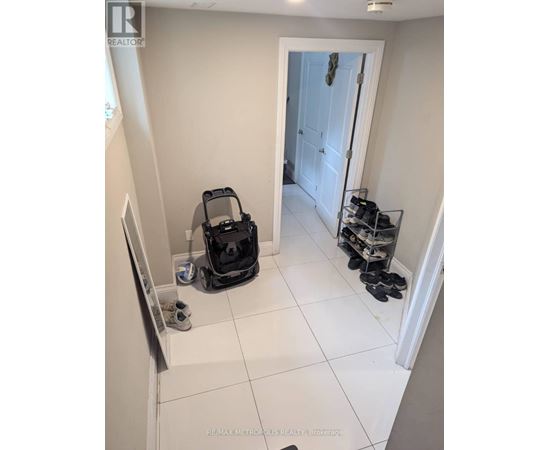A room with a vacuum cleaner and shoes.