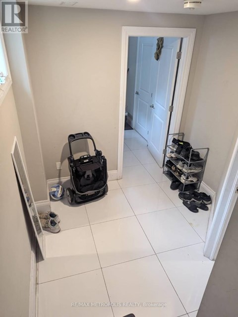A room with a vacuum cleaner and shoes.