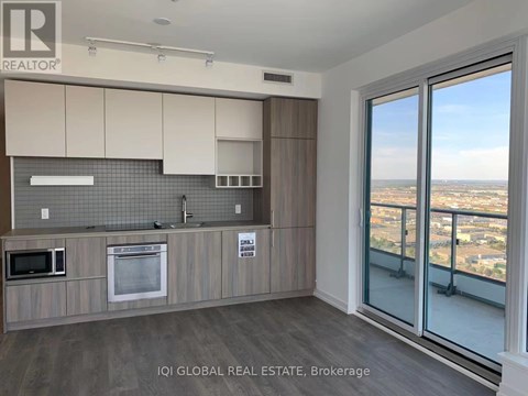 A kitchen with a view of the city.