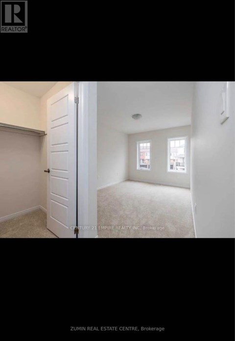 A brochure for a real estate company showing a bedroom with a window.