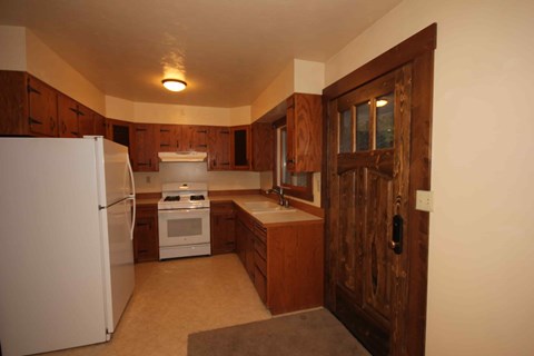 A kitchen with a white refrigerator and a white stove.