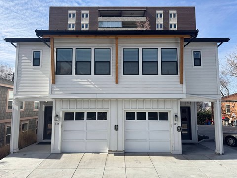 A two-story house with a white garage door.