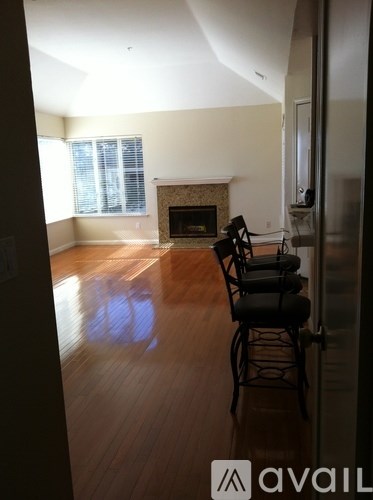 A living room with a fireplace and a chair.