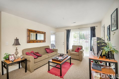 A living room with a couch, chair, and coffee table.