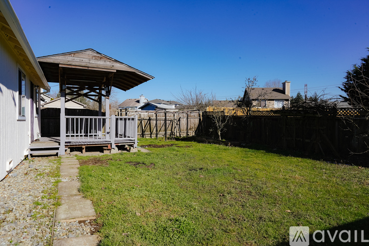 A gazebo is in the middle of a grassy area.