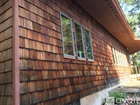 A house with a brown wooden exterior and a window.