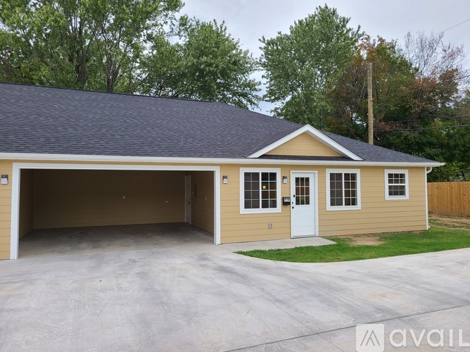 A two-car garage with a beige exterior and a black roof.