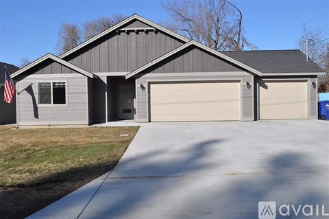A house with a grey exterior and a garage door.
