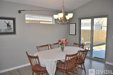 A dining room with a round table and chairs.