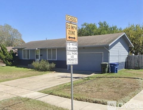 A sign in front of a house states that it is a 20 mph zone.