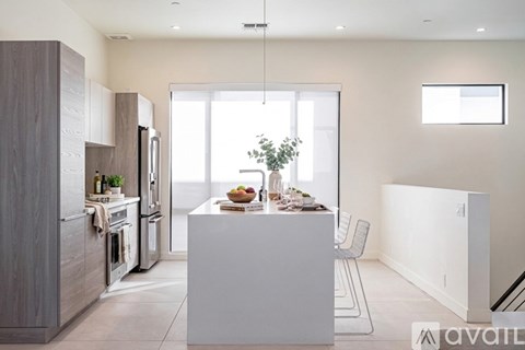 A modern kitchen with a dining table and chairs.
