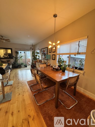 A dining room with a wooden table and chairs.