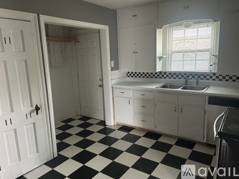 A black and white checkered floor in a kitchen.