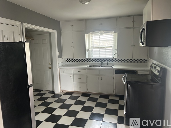 A black and white checkered floor in a kitchen.