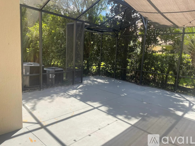 A patio area with a glass wall and a white floor.
