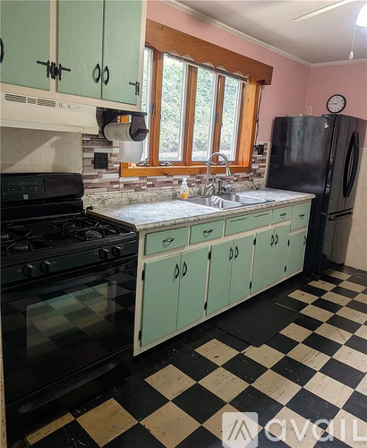 A kitchen with black and white checkered floor.