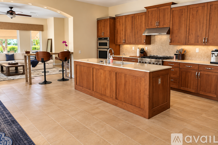 A kitchen with wooden cabinets and a large island.