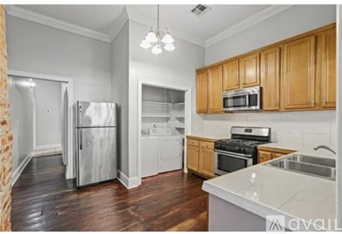 A kitchen with wooden cabinets and a white countertop.